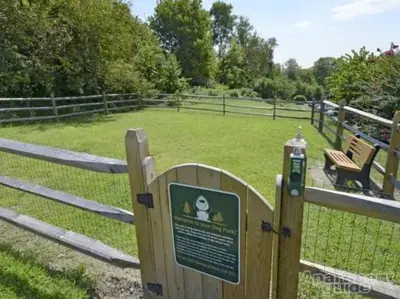 a park with a fence and a sign in a field at Pine Brook 118 I Modern Corporate 2bd I Parking in Newark