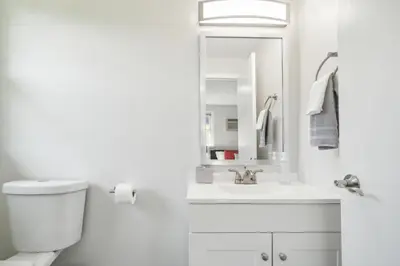 a white bathroom with a sink and a mirror at Pine Brook 1218 I Cozy & comfy I Free Parking in Newark