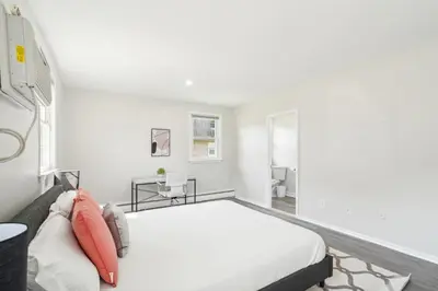 a white bedroom with a bed and a couch at Pine Brook 1218 I Cozy & comfy I Free Parking in Newark
