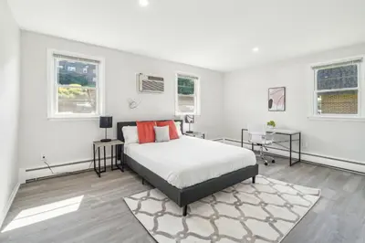 a white bedroom with a bed and two windows at Pine Brook 1218 I Cozy & comfy I Free Parking in Newark