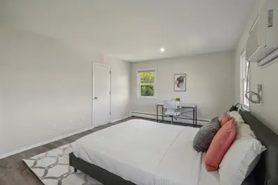 a white bedroom with a large bed and a window at Pine Brook 124 I Modern Gem I Free Parking in Newark