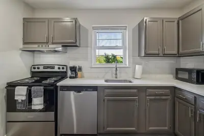 a kitchen with stainless steel appliances and a window at Pine Brook 124 I Modern Gem I Free Parking in Newark