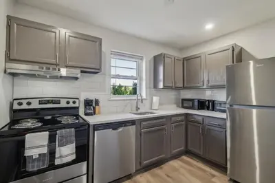 a kitchen with stainless steel appliances and a window at Pine Brook 124 I Modern Gem I Free Parking in Newark