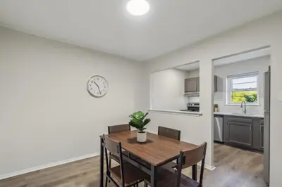 a kitchen and dining room with a wooden table and chairs at Pine Brook 124 I Modern Gem I Free Parking in Newark
