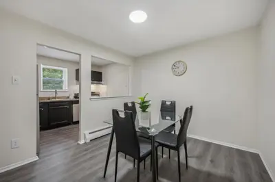 a dining room and kitchen with a table and chairs at Pine Brook 1302 I Pool Gym I Free Parking ! in Newark