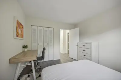 a white bedroom with a desk and a bed at Pine Brook 1302 I Pool Gym I Free Parking ! in Newark