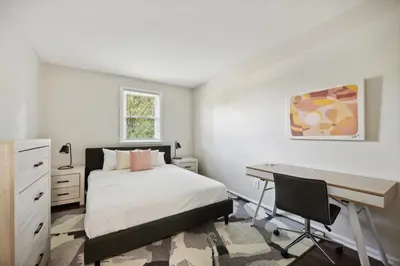 a bedroom with a bed and a desk and a desk at PineBrook 1406 I 2br Garden Style Apartment ! in Newark