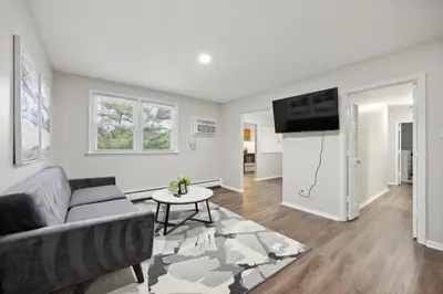 a living room with a couch and a flat screen tv at PineBrook 1406 I 2br Garden Style Apartment ! in Newark