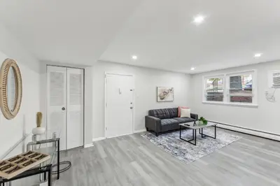 a living room with a couch and a table at Pine Brook 416 I Corporate 15Br Apartment ! Pool in Newark