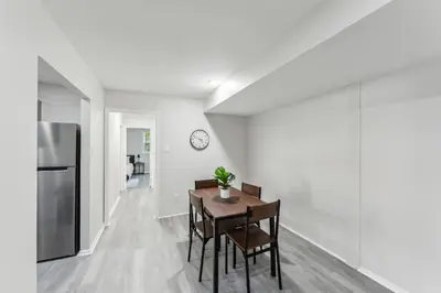 a kitchen and dining room with a table and a refrigerator at Pine Brook 416 I Corporate 15Br Apartment ! Pool in Newark