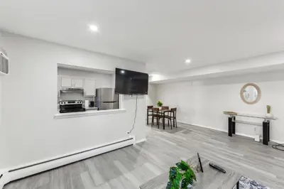 a white living room with a refrigerator and a table at Pine Brook 416 I Corporate 15Br Apartment ! Pool in Newark