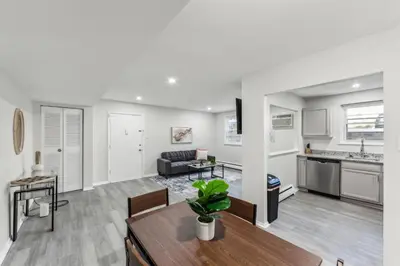 a living room with a table and a kitchen at Pine Brook 416 I Corporate 15Br Apartment ! Pool in Newark