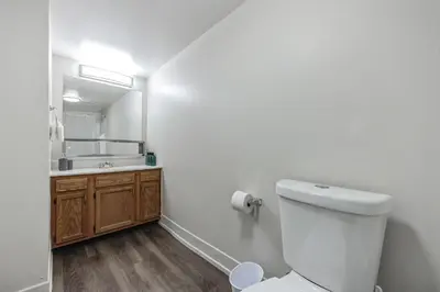 a bathroom with a toilet and a sink and a mirror at Pine Brook 502 I Pool Gym I Free Parking ! in Newark