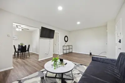 a living room with a couch and a table at Pine Brook 502 I Pool Gym I Free Parking ! in Newark
