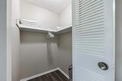 a walk in closet with a white door and a shelf at Pine Brook 502 I Pool Gym I Free Parking ! in Newark