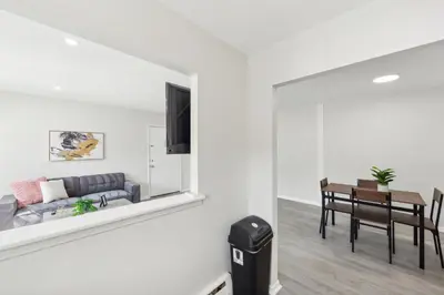 a living room with a couch and a table at Pine Brook 509 I Corporate 15Br Apt I Parking in Newark