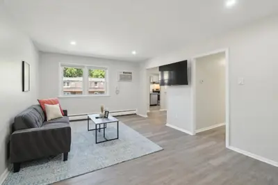 a living room with a couch and a table at Pine Brook 518 I Spacious 2Bd Garden Style Oasis in Newark