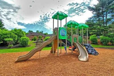 a playground with slides and umbrellas in a park at Pine Brook 518 I Spacious 2Bd Garden Style Oasis in Newark