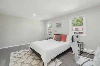 a white bedroom with a bed and two windows at Pine Brook 518 I Spacious 2Bd Garden Style Oasis in Newark