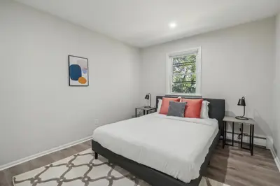 a white bedroom with a bed and a window at Pine Brook 618 I Cozy & Roomy I Gym & Pool in Newark