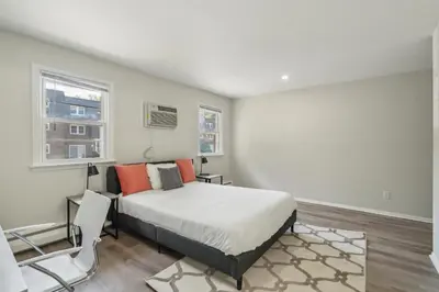 a bedroom with a bed and two windows at Pine Brook 618 I Cozy & Roomy I Gym & Pool in Newark