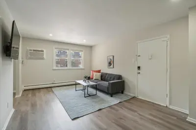 a living room with a couch and a table at Pine Brook 618 I Cozy & Roomy I Gym & Pool in Newark
