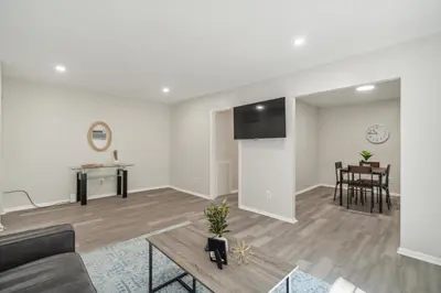 a living room with a couch and a table at Pine Brook 808 I Your Newark Retreat I Pool & Gym in Newark