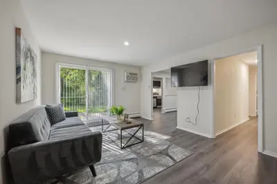 a living room with a couch and a table at Pine Brook 816 I Corporate 2Br Apartment ! in Newark