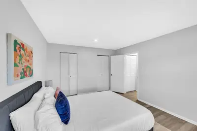 a bedroom with a bed with a blue pillow on it at Pine Brook 817 I Corporate 1Br Apartment ! in Newark