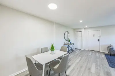 a white dining room with a white table and chairs at Pine Brook 817 I Corporate 1Br Apartment ! in Newark