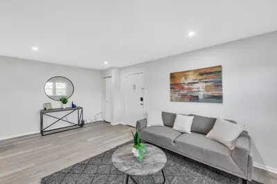 a living room with a couch and a table at Pine Brook 817 I Corporate 1Br Apartment ! in Newark