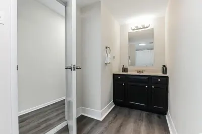 a bathroom with a black vanity and a mirror at Pine Brook 818 I Pool Gym I Free Parking ! in Newark
