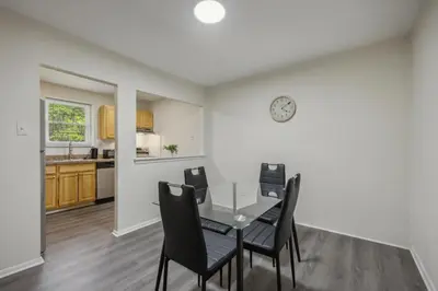 a dining room with a table and chairs at Pine Brook 818 I Pool Gym I Free Parking ! in Newark