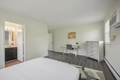 a white bedroom with a bed and a desk at Pine Brook 818 I Pool Gym I Free Parking ! in Newark
