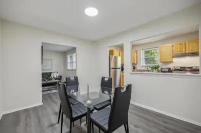 a dining room with a table and chairs and a kitchen at Pine Brook 818 I Pool Gym I Free Parking ! in Newark