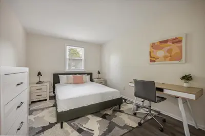 a bedroom with a bed and a desk and a desk at Pine Brook 818 I Pool Gym I Free Parking ! in Newark