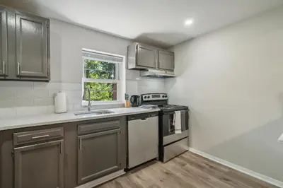 a kitchen with stainless steel appliances and a window at Pine Brook 908 I Lovely 2Bd Spacious Apartment in Newark