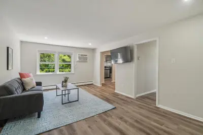 a living room with a couch and a table at Pine Brook 908 I Lovely 2Bd Spacious Apartment in Newark