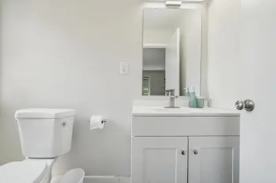 a white bathroom with a toilet and a sink at Pine Brook 908 I Lovely 2Bd Spacious Apartment in Newark