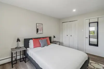 a white bedroom with a large bed and a window at Pine Brook 908 I Lovely 2Bd Spacious Apartment in Newark