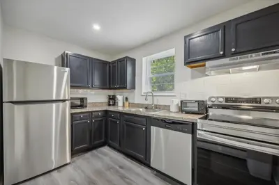 a kitchen with black cabinets and stainless steel appliances at PineBrook 914 I Popular 2Br Apartment for rent ! in Newark