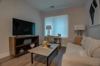 a living room with a couch and a tv at Landing at Hagert and York 1 Bedroom in East Kensington in Philadelphia