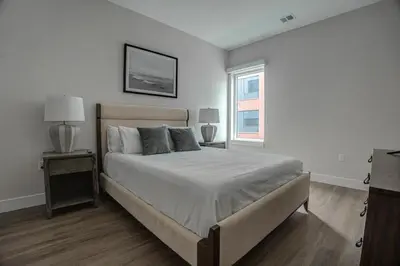 a white bedroom with a bed and a window at Landing at Hagert and York 1 Bedroom in East Kensington in Philadelphia