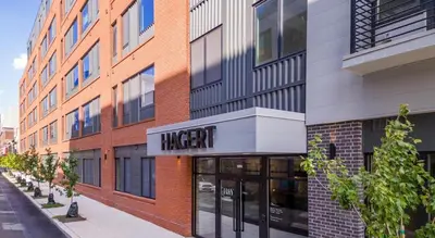 a large brick building with a higer sign on it at Landing at Hagert and York 1 Bedroom in East Kensington in Philadelphia