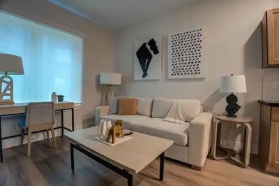 a living room with a couch and a table at Landing at Hagert and York 1 Bedroom in East Kensington in Philadelphia