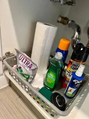 a shelf in a bathroom with toiletries and cleaning products at 404 Rose in the city 1 BD living room in center city in Philadelphia