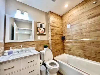 a bathroom with a toilet and a sink and a tub at 404 Rose in the city 1 BD living room in center city in Philadelphia