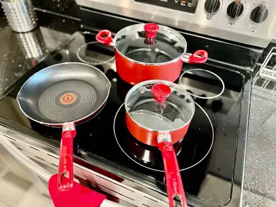 two pots and pans sitting on top of a stove at 404 Rose in the city 1 BD living room in center city in Philadelphia