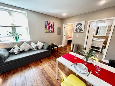 a living room with a couch and a table at 404 Rose in the city 1 BD living room in center city in Philadelphia
