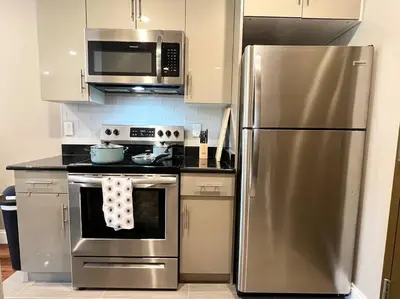 a kitchen with a stainless steel refrigerator and microwave at 403 Luxury and Comfy King bed in Central city of phily in Philadelphia